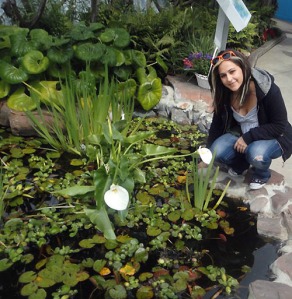 Nora by a beautiful flower and pond at Seaworld. 
